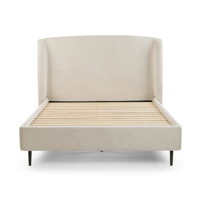 Beige upholstered bed with wooden slats on a white background