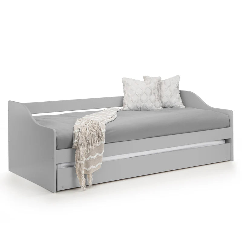 Gray sofa bed with a blanket and pillows on a white background