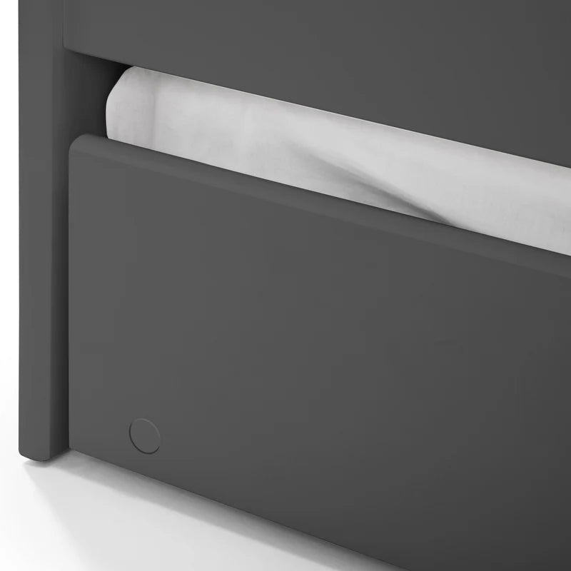 Close-up of a dark gray cabinet with a white roll of paper towel inside.