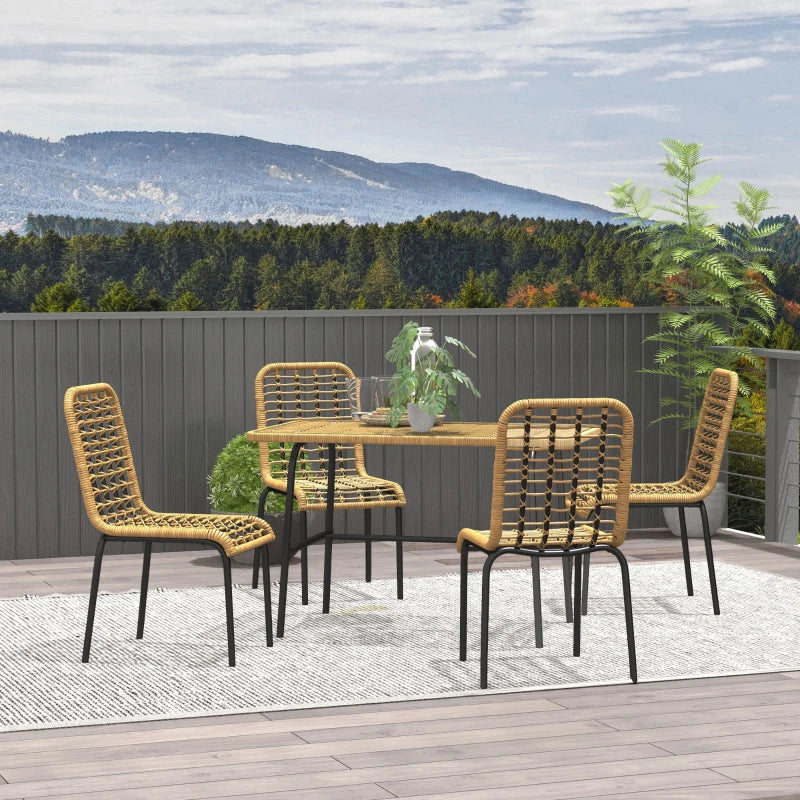 Outdoor dining set with four chairs and a table on a deck with a scenic background.
