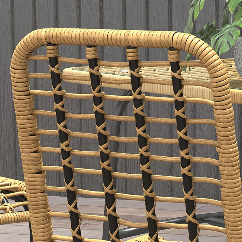 Wicker chair with black and beige pattern against a gray wall.