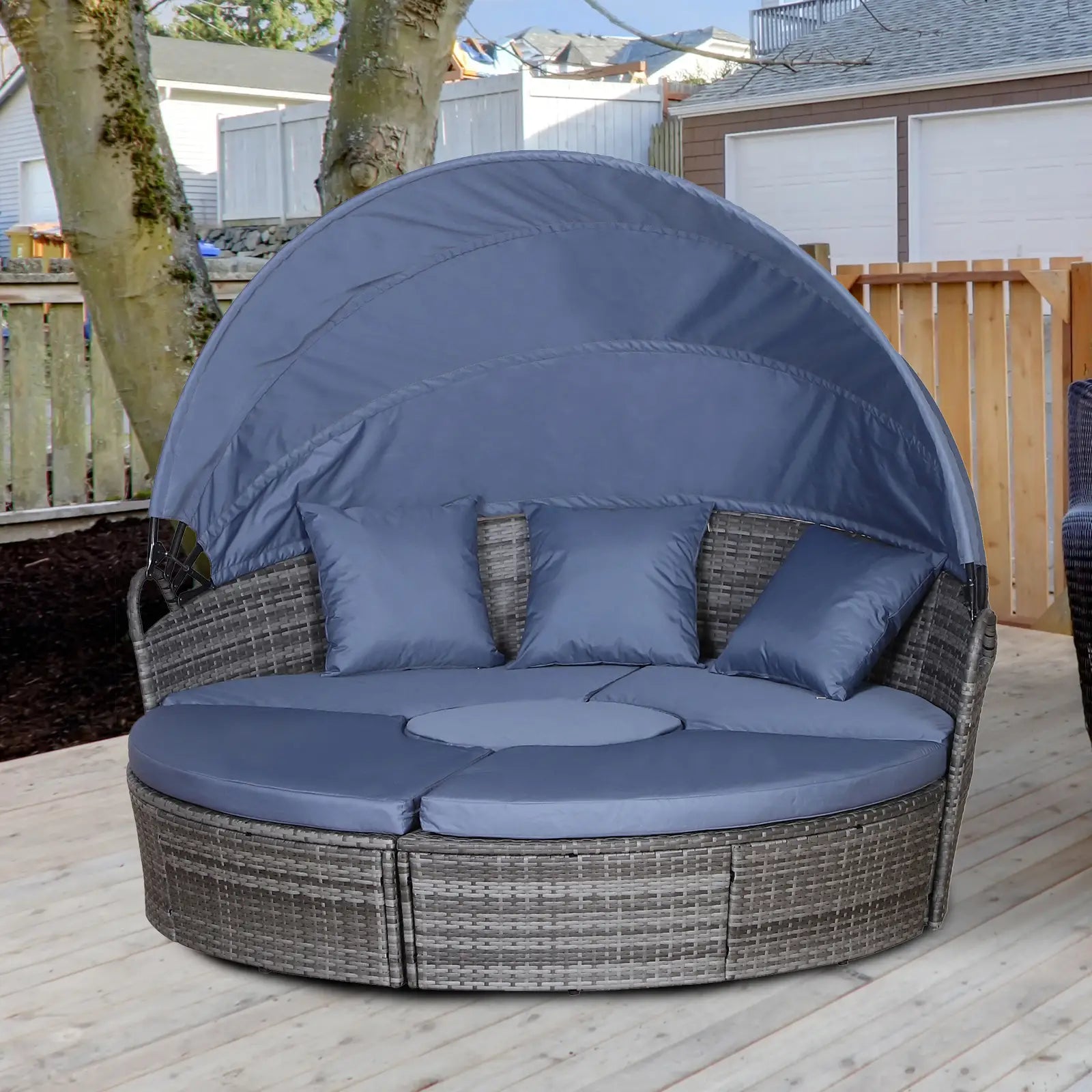 Round outdoor lounge chair with canopy and blue cushions on a wooden deck.