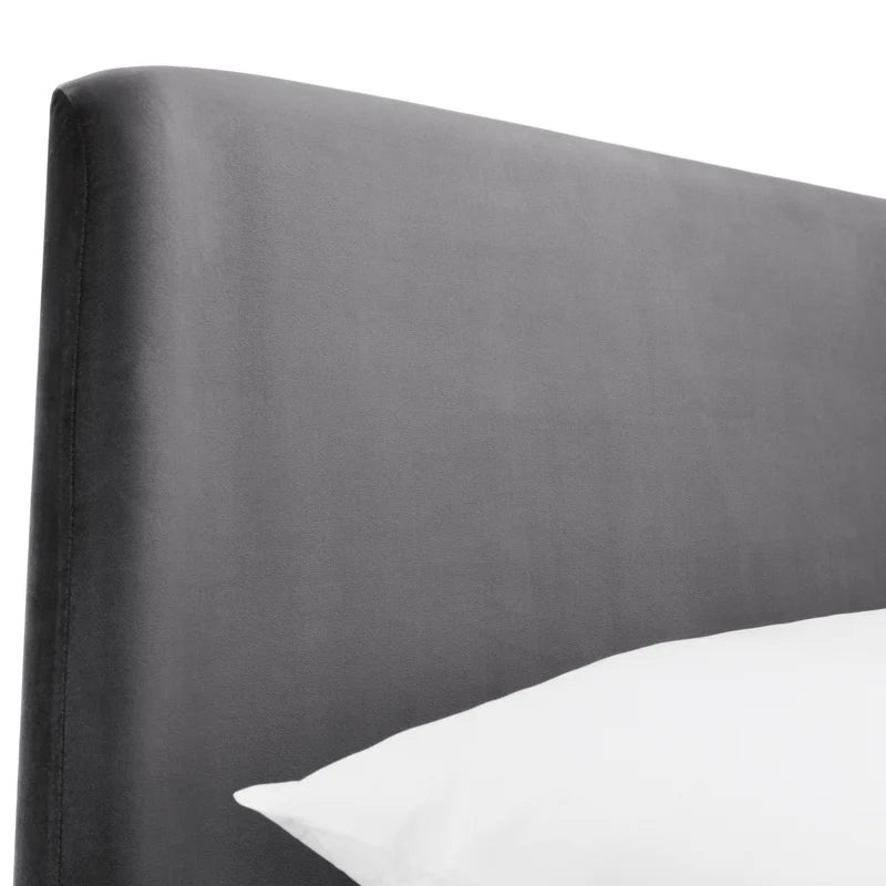 Gray upholstered headboard with a white pillow on a white background
