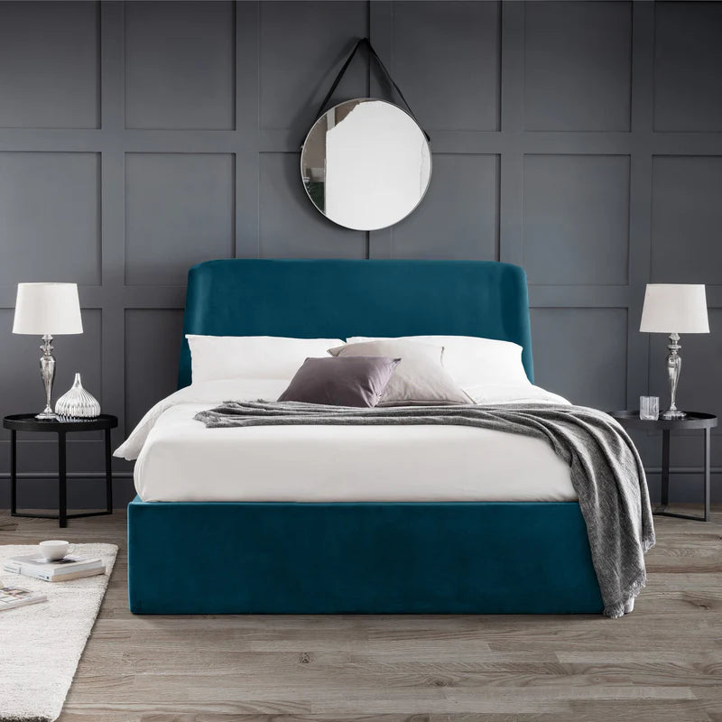 Modern bedroom with a teal bed and gray walls