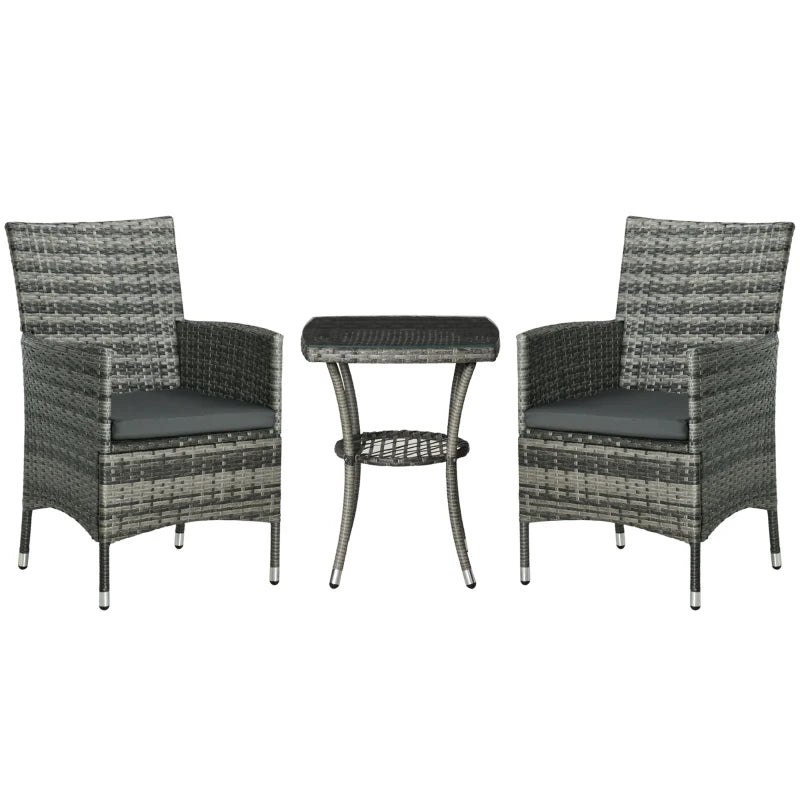 Two wicker chairs with a matching table on a white background