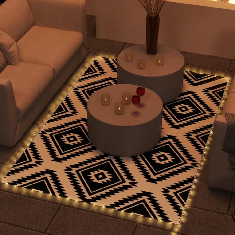 Living room with a patterned rug, coffee table, and decorative items.