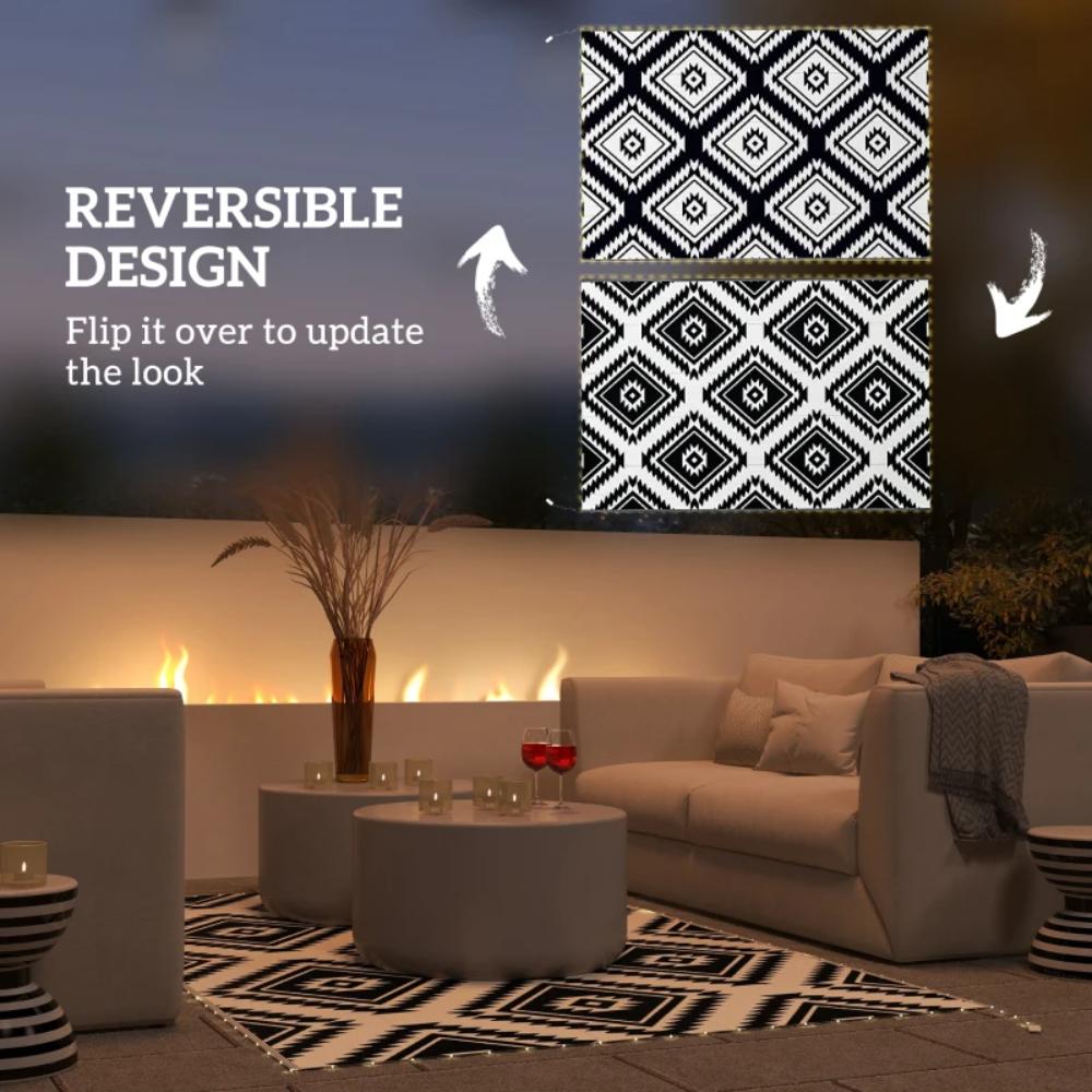 Living room with reversible black and white patterned rug and wall art.