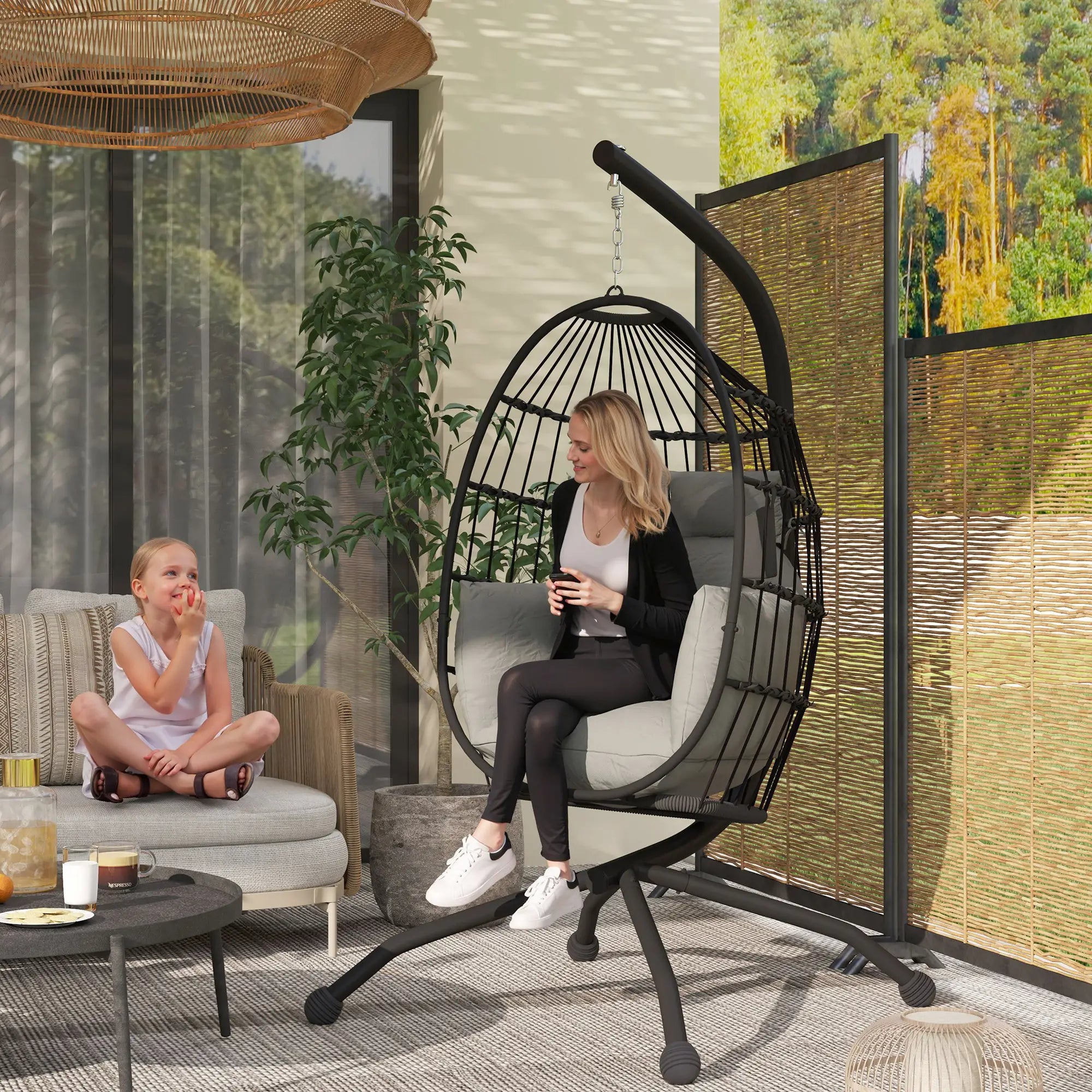 Woman and child in a modern outdoor living space with a hanging chair and plants.