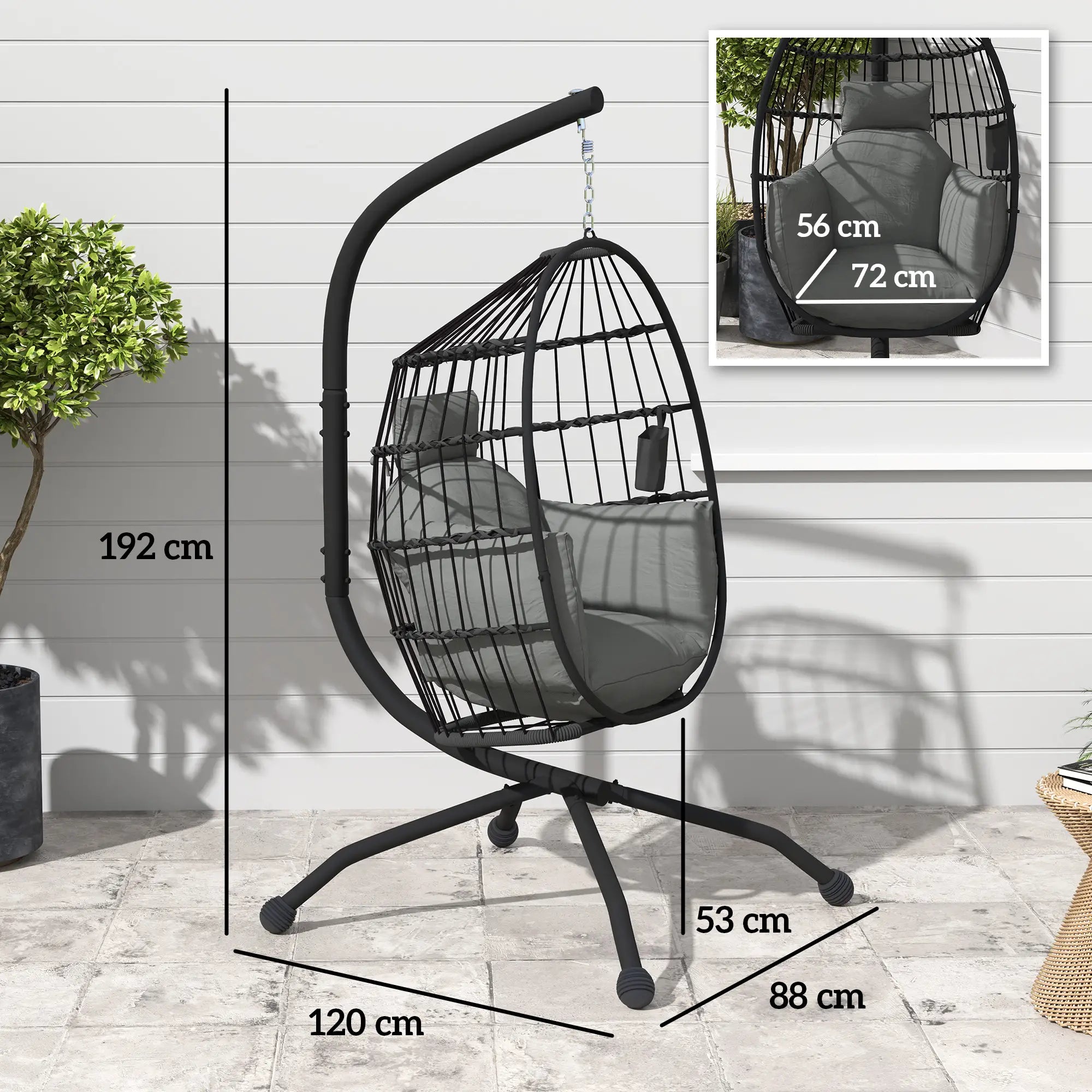 Black egg-shaped hanging chair with dimensions on a wooden floor.