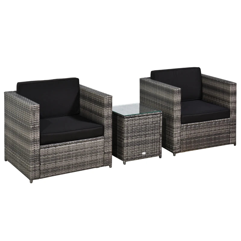 Two wicker chairs with black cushions and a matching table on a white background