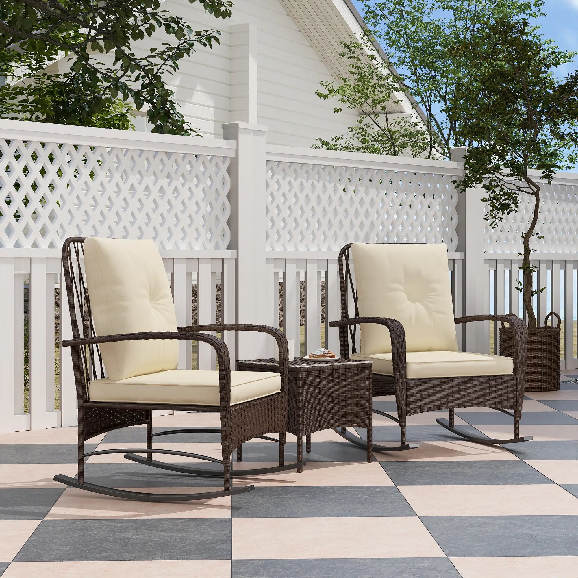 Two wicker rocking chairs with beige cushions on a patio.