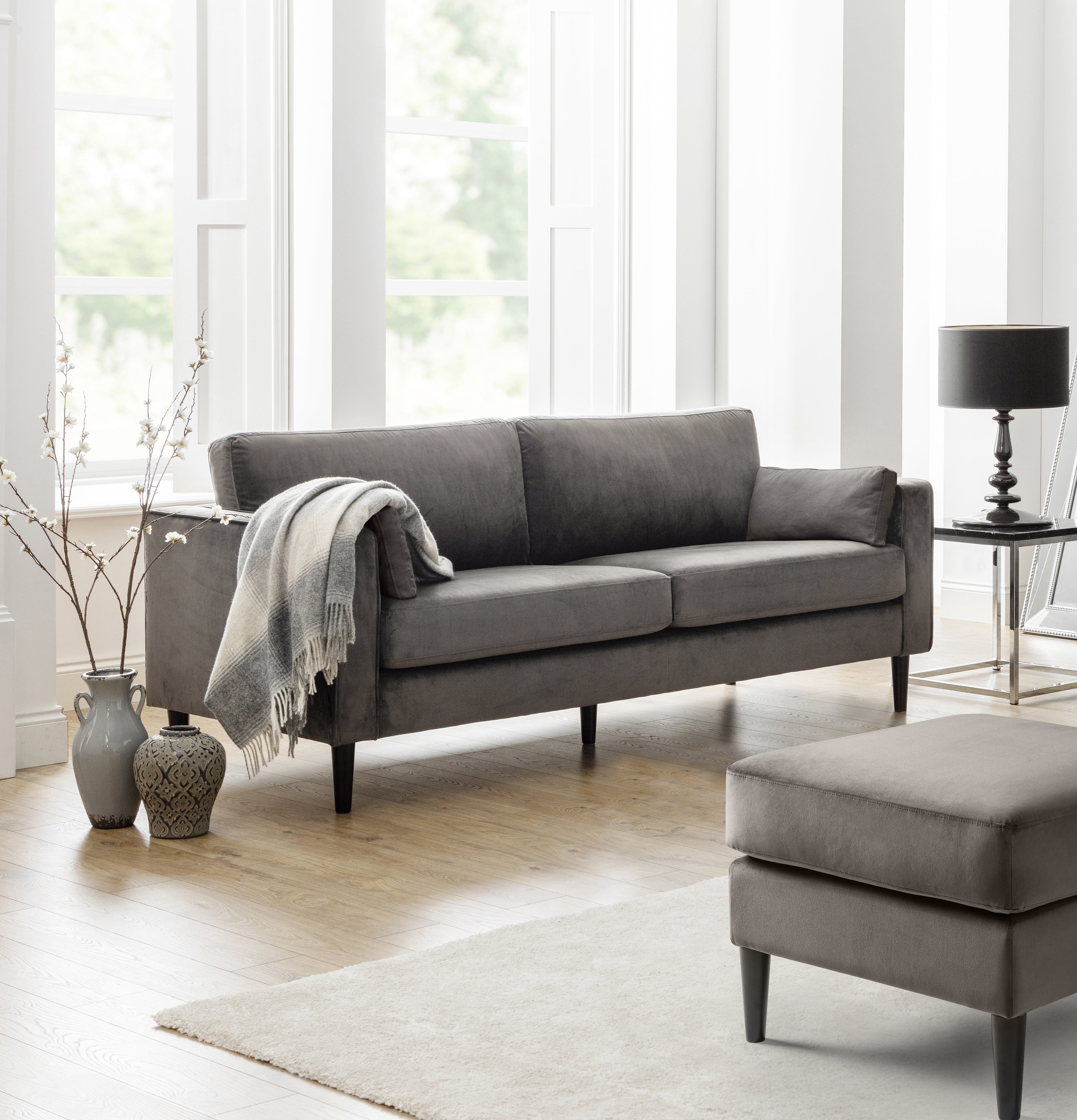 Gray sofa with a matching ottoman in a bright living room.