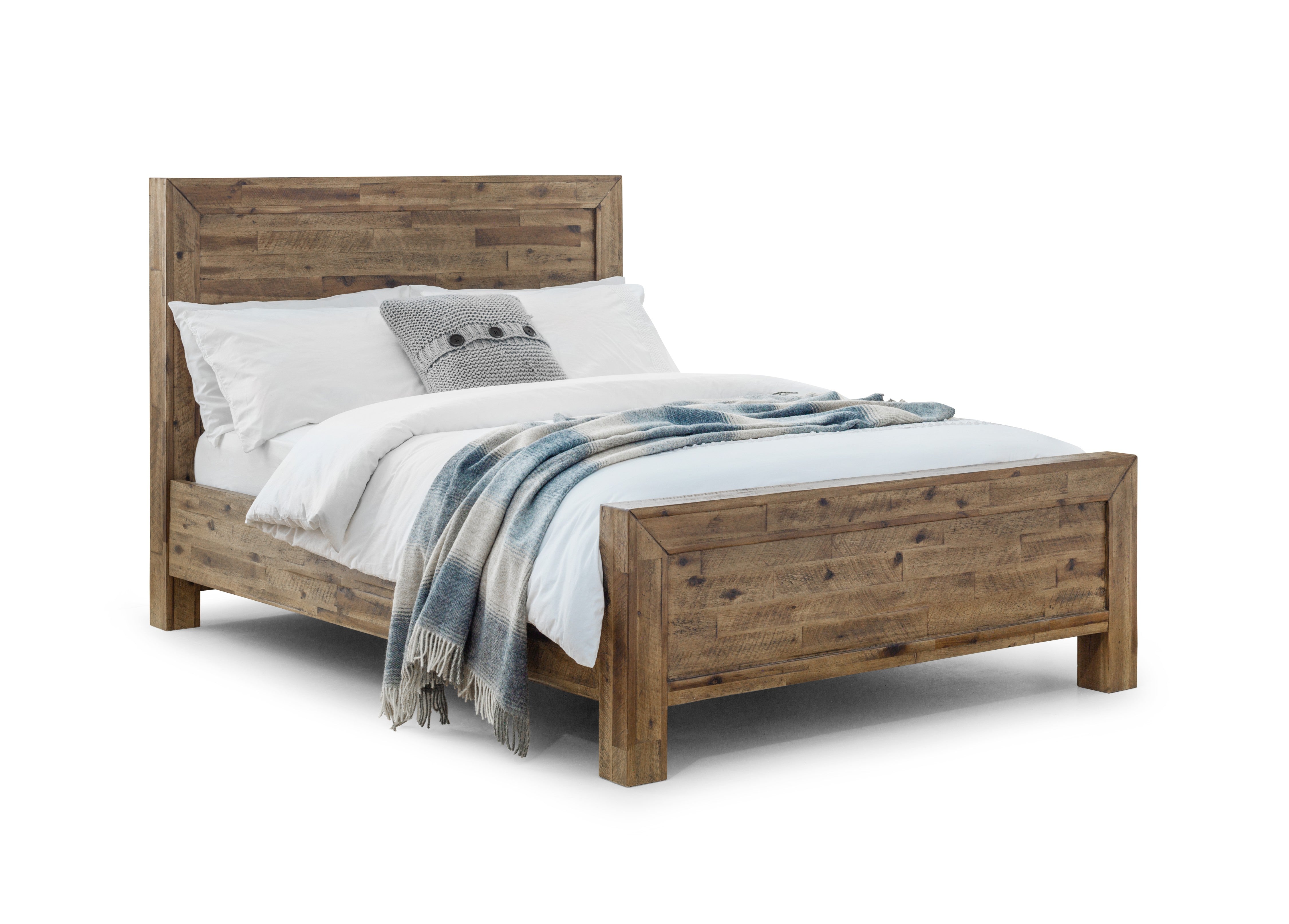 Wooden bed with white bedding and a gray blanket on a white background