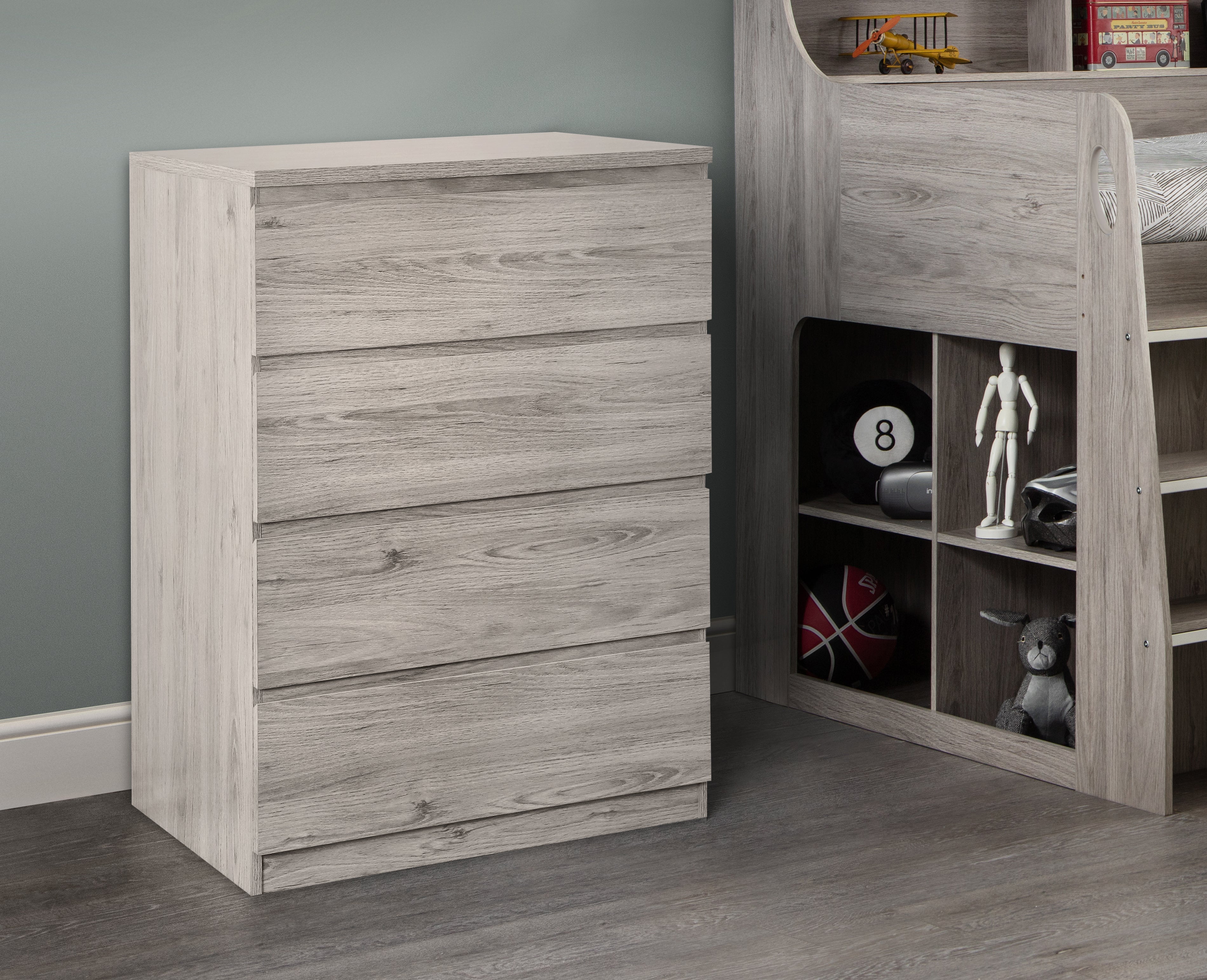 Wooden dresser and bookshelf in a room with toys and decor.