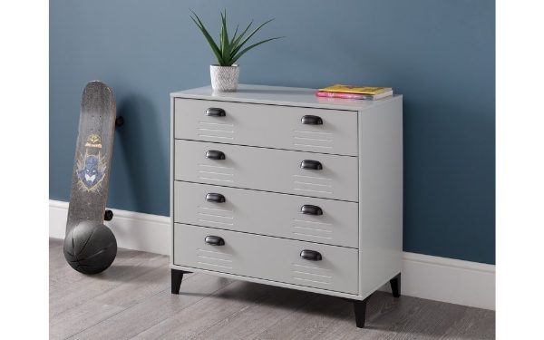 Gray dresser with black drawers against a blue wall, skateboard and plant on top.