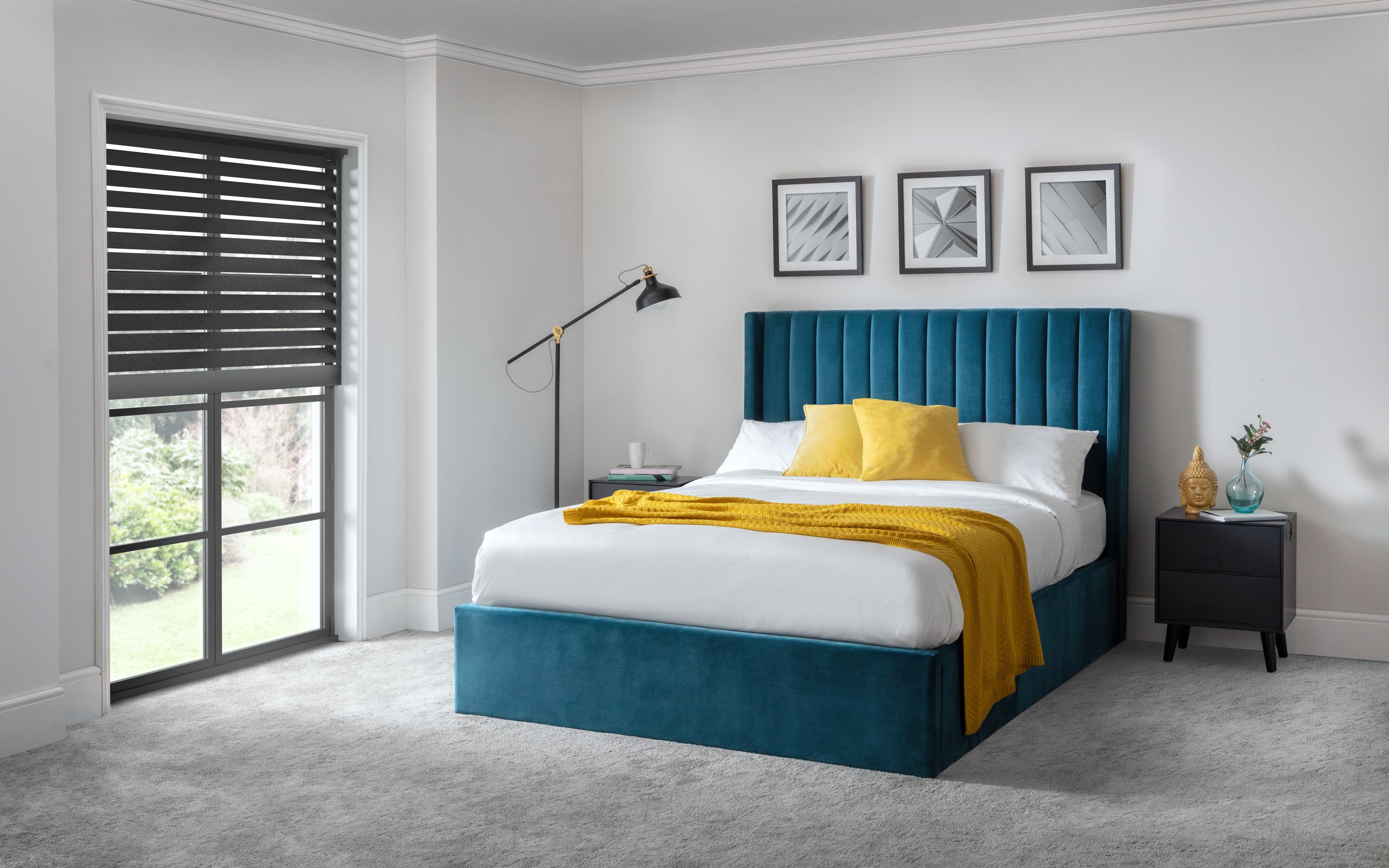 Modern bedroom with a blue bed and yellow blanket