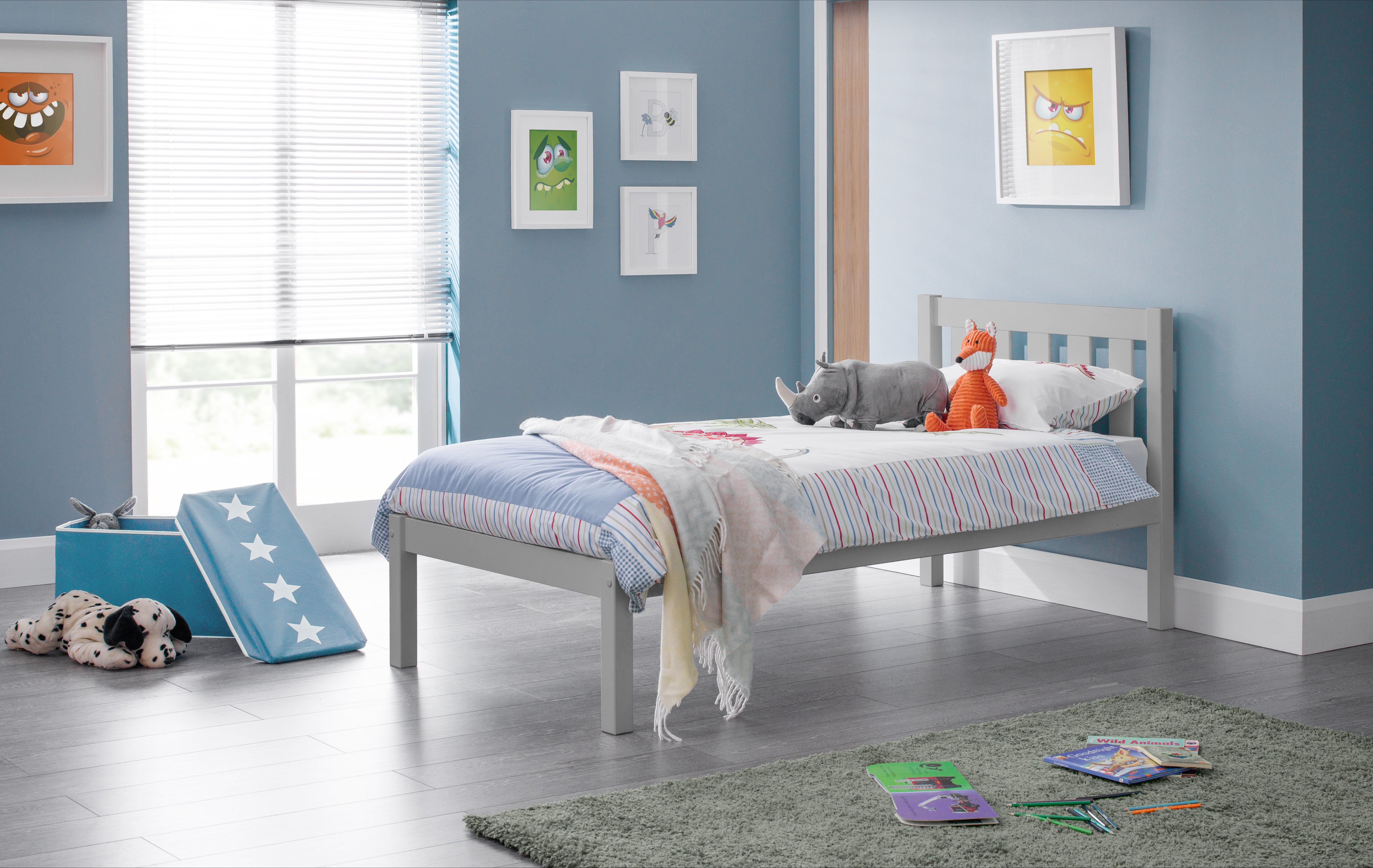 Children's bedroom with a bed, toys, and colorful bedding.