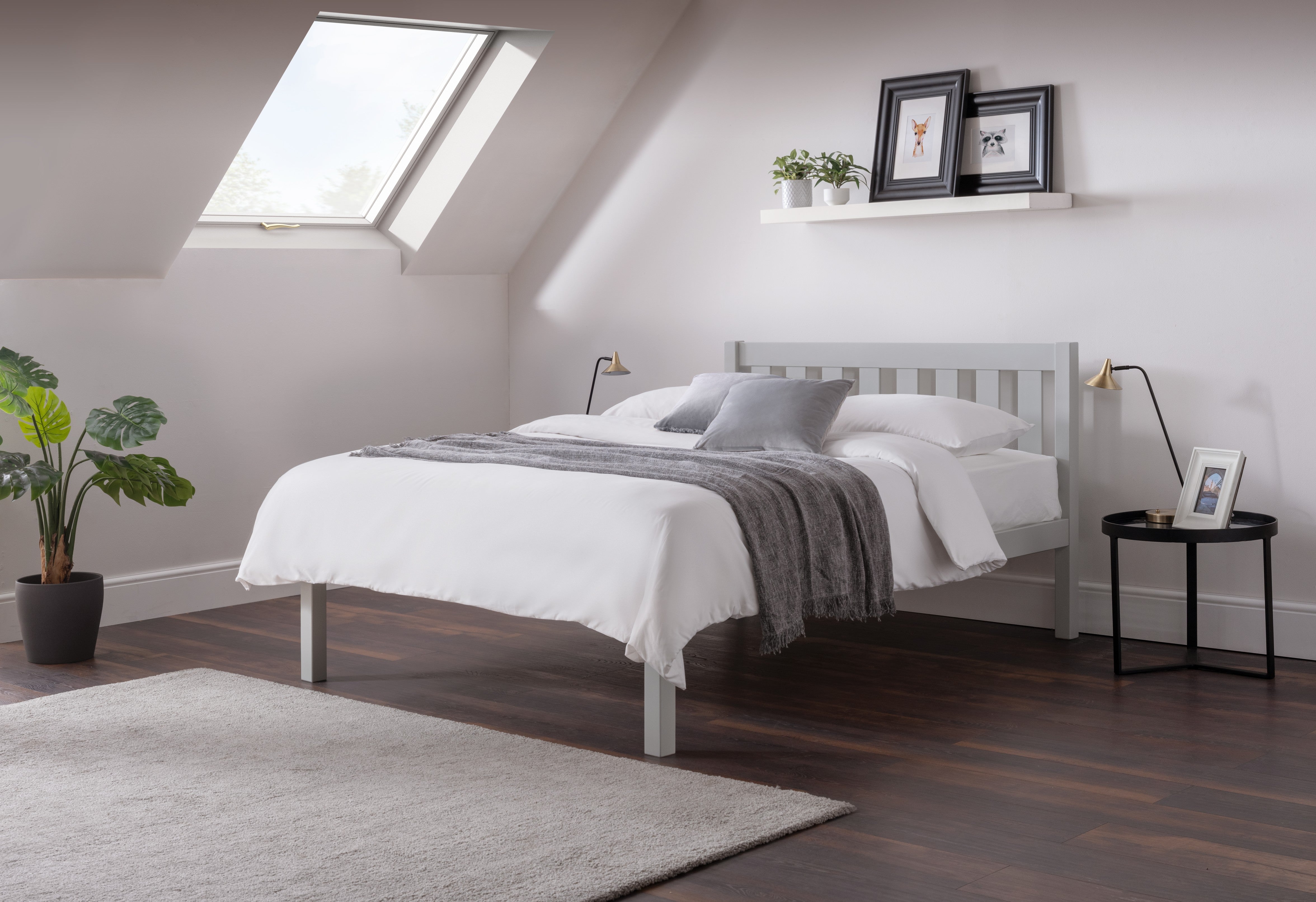 Modern bedroom with a bed, side table, and decorative elements.