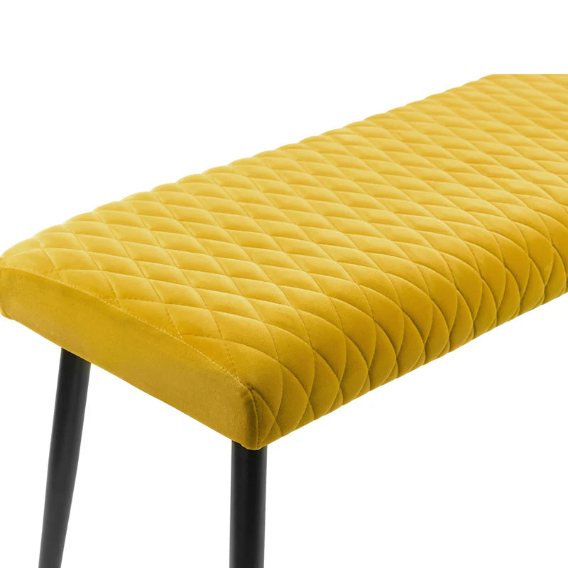 Yellow quilted bench with black legs on a white background