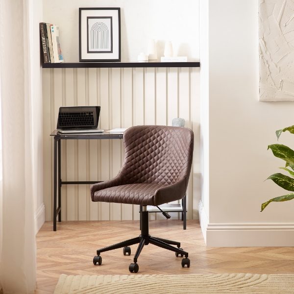 Brown quilted office chair in a home office setting with a desk and decor.