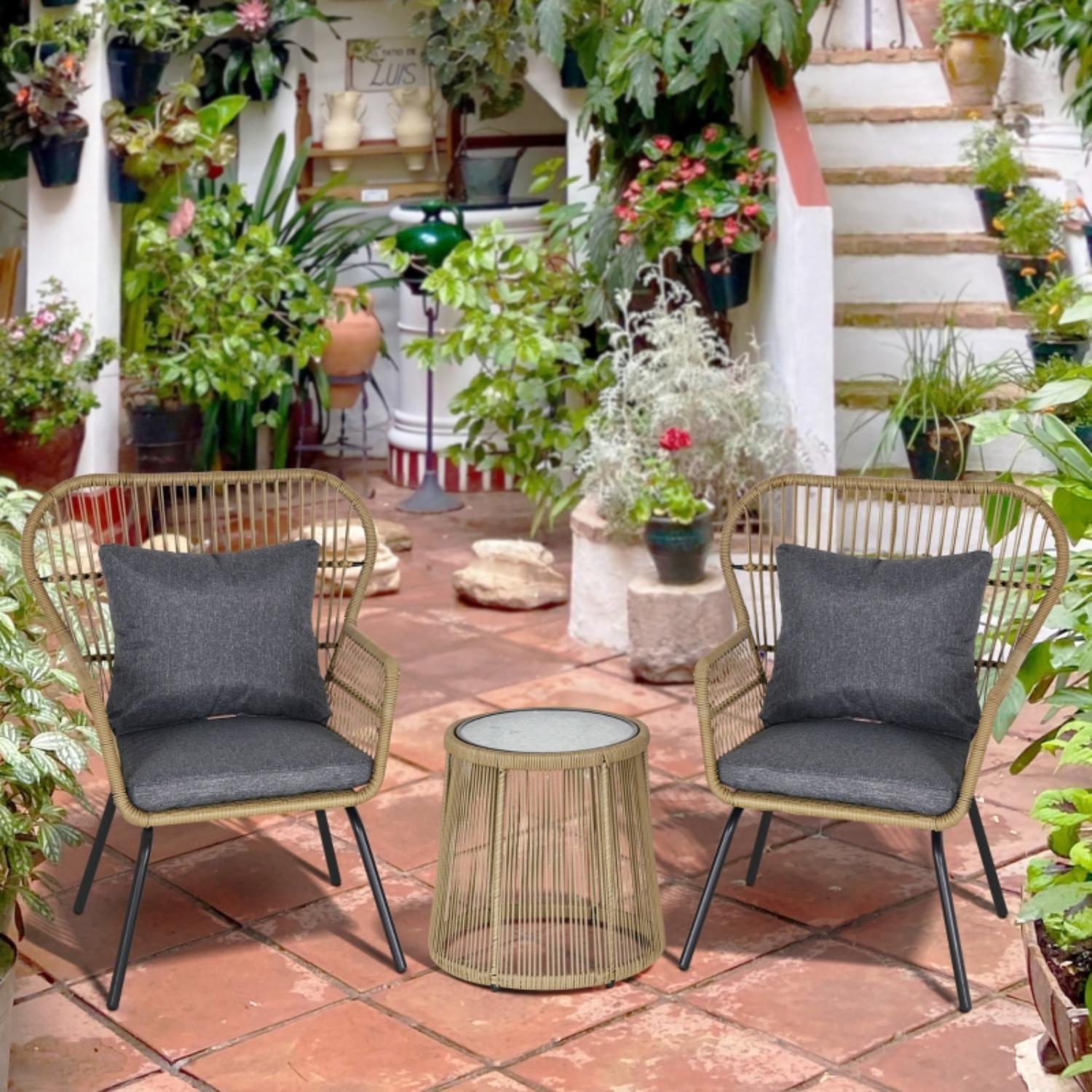 Outdoor patio with two chairs, a small table, and potted plants on a tiled floor.