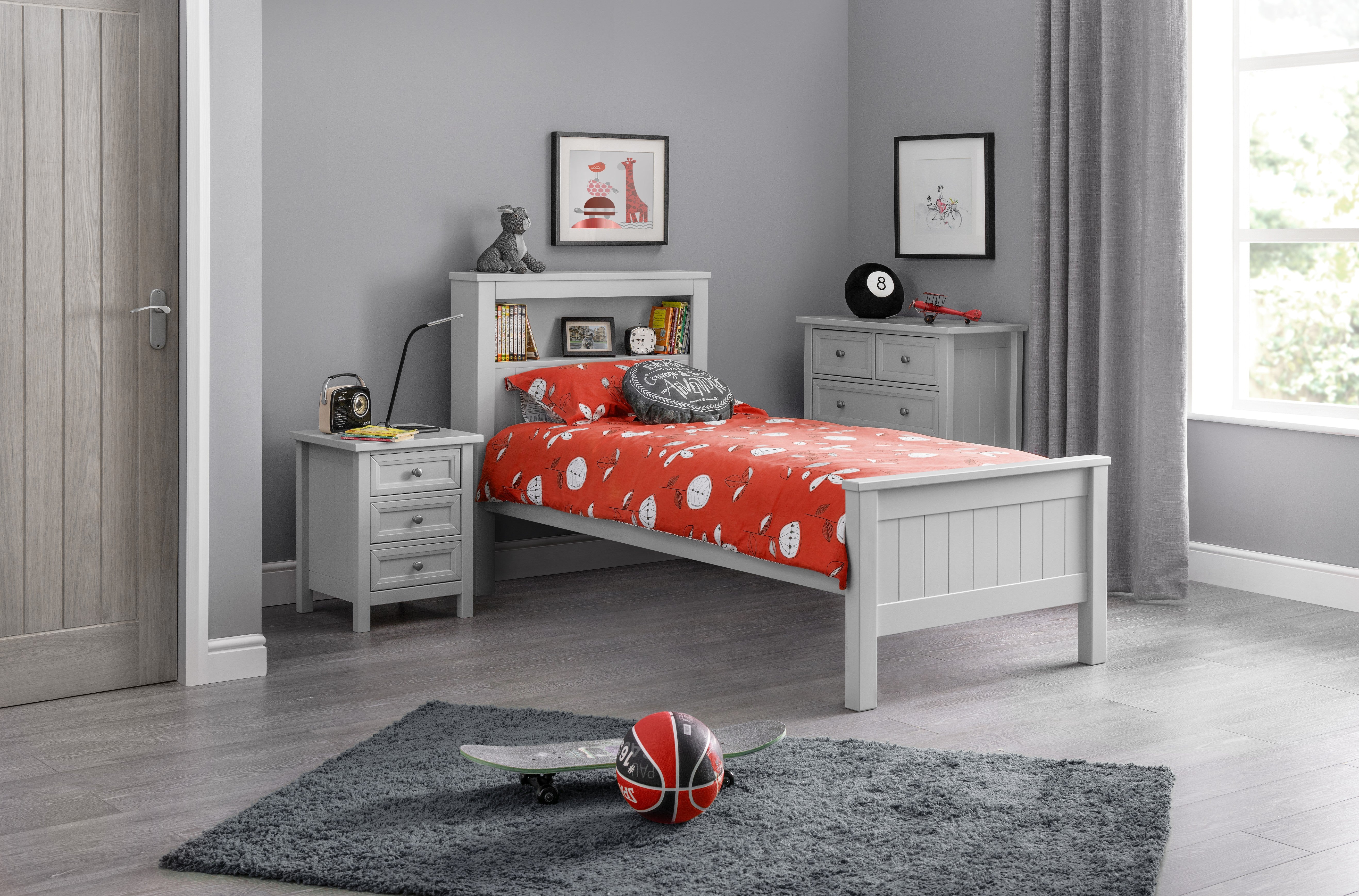 Children's bedroom with a bed, nightstands, and decor items.