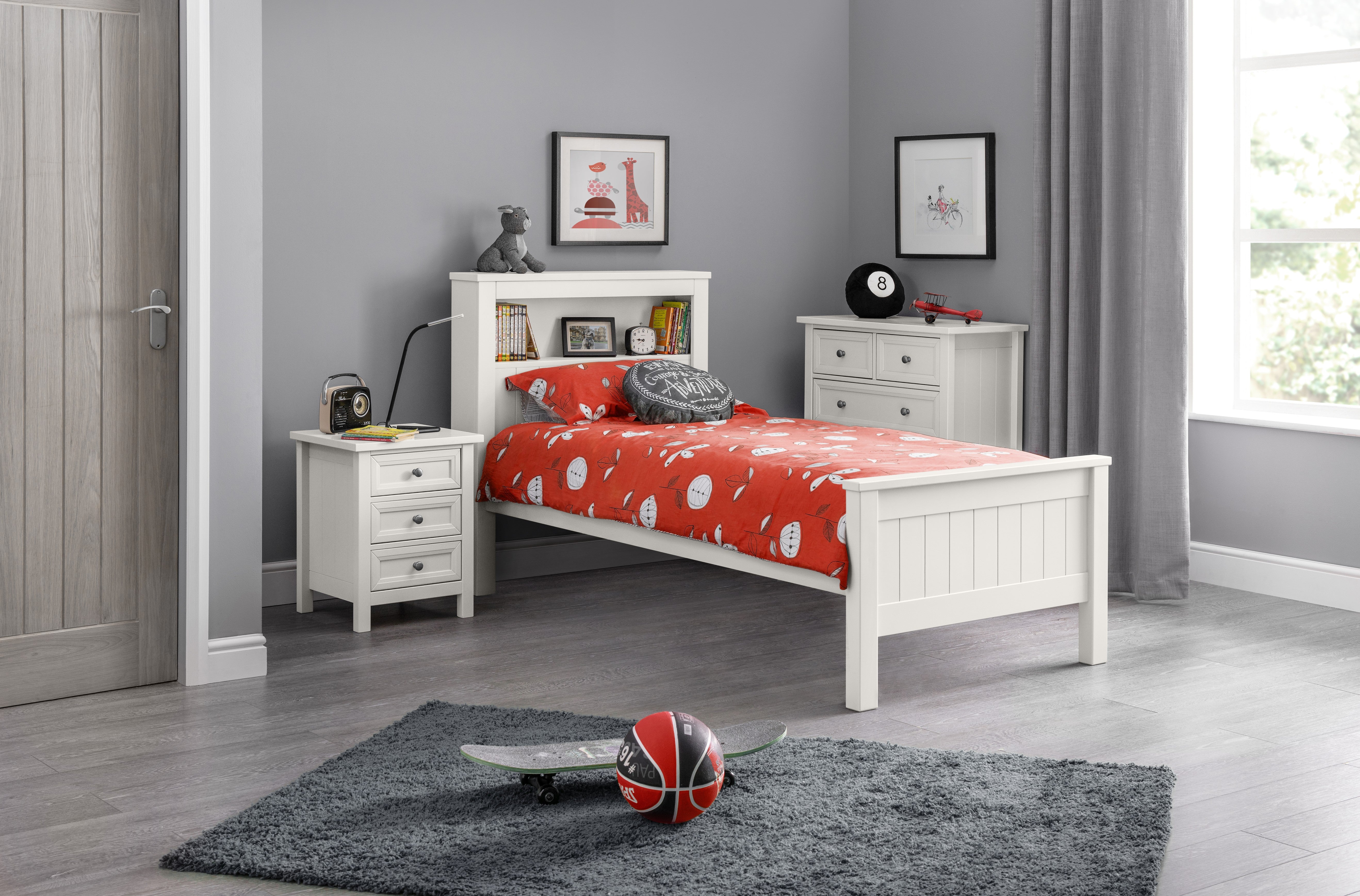 Children's bedroom with a white bed, red bedding, and gray walls.