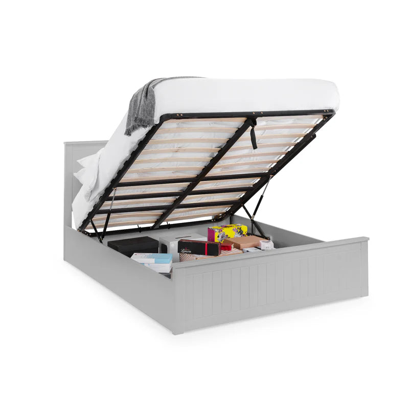 Gray bed with open storage compartment on a white background