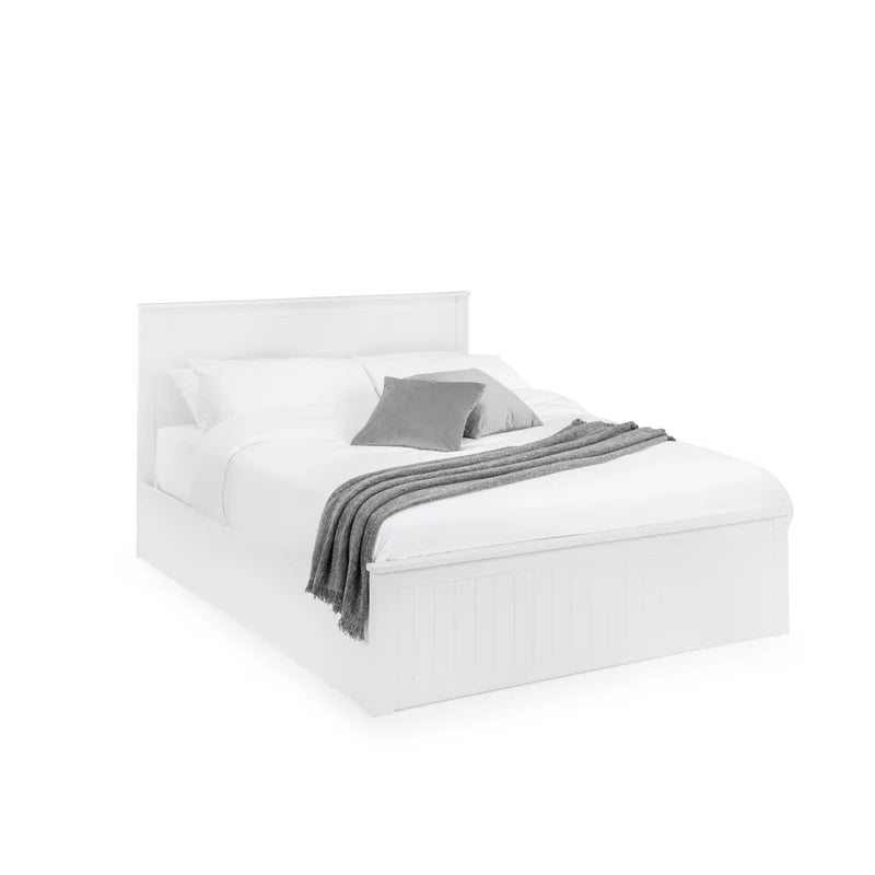 White bed with gray bedding on a white background
