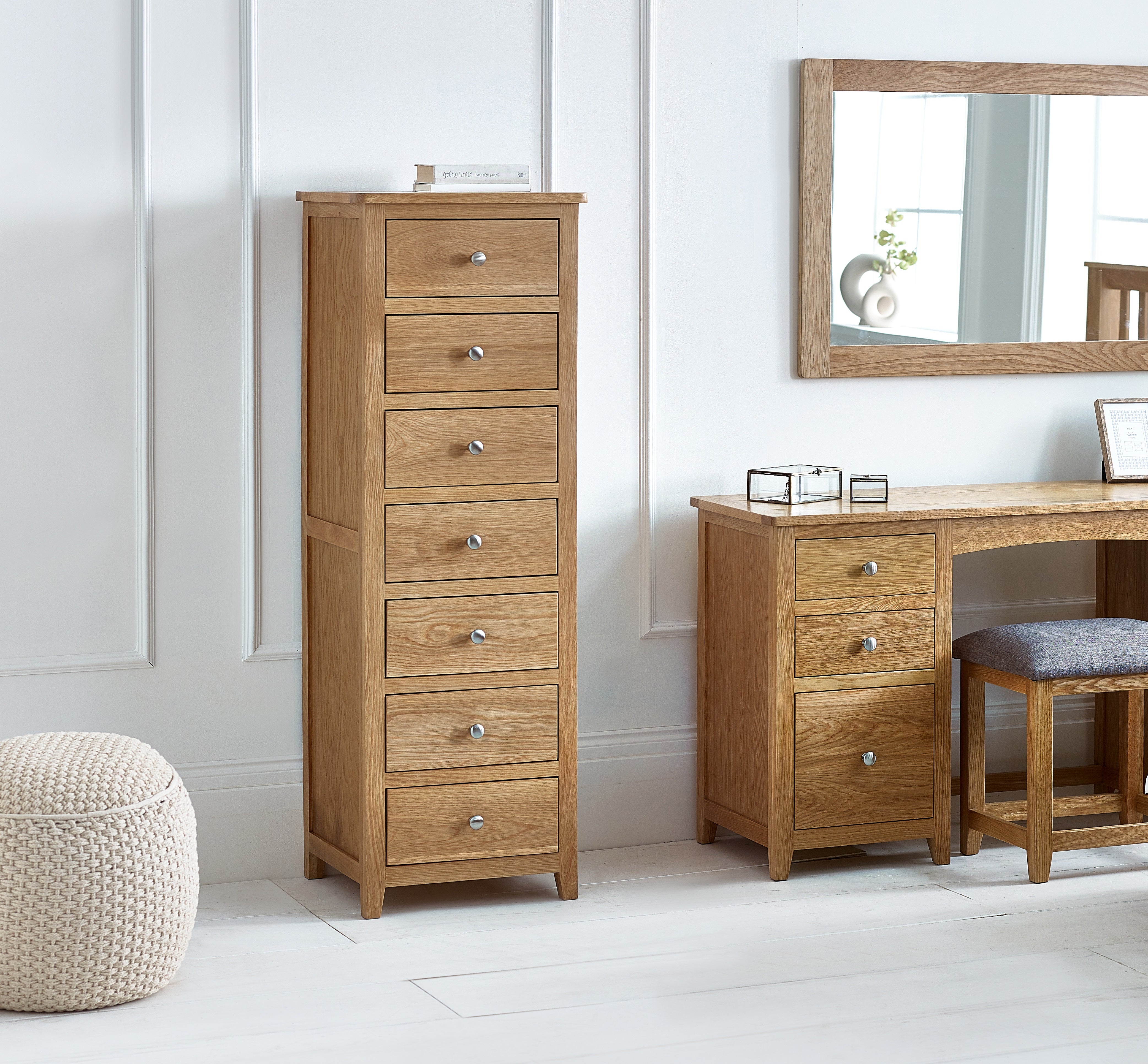 Wooden dresser with multiple drawers in a room setting.