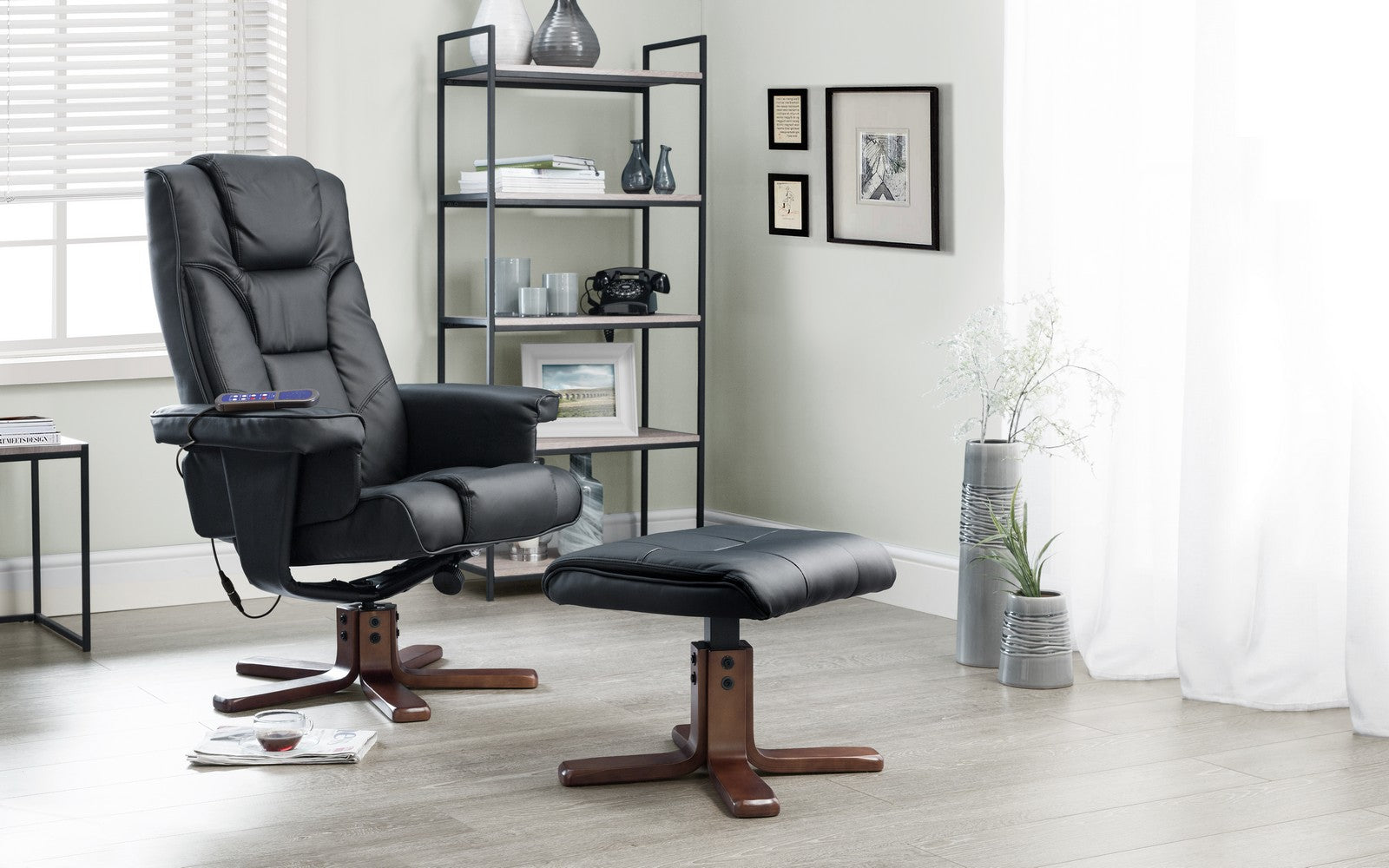 Black recliner chair with ottoman in a home office setting