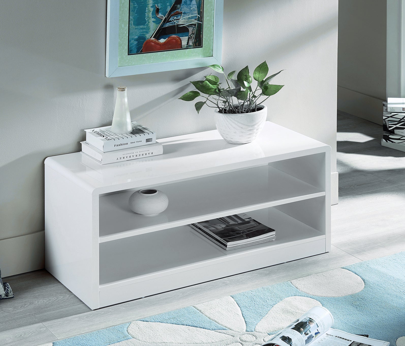 White TV stand with decorative items in a room setting