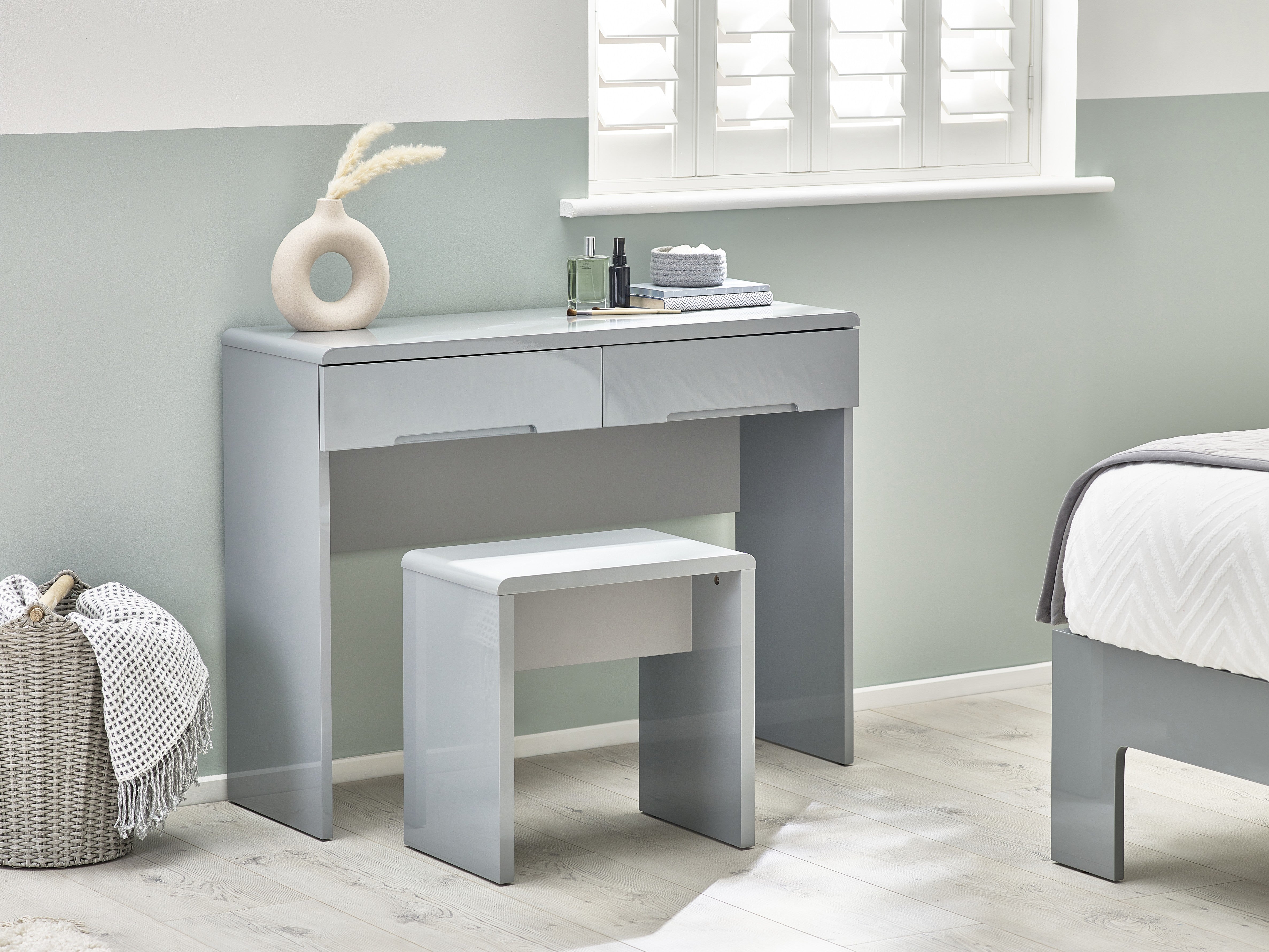 Gray vanity table with a stool in a bedroom setting