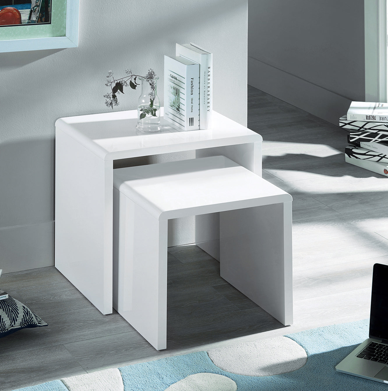 White modern desk with a laptop on a rug in a room setting