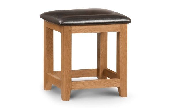 Wooden stool with a brown leather seat on a white background