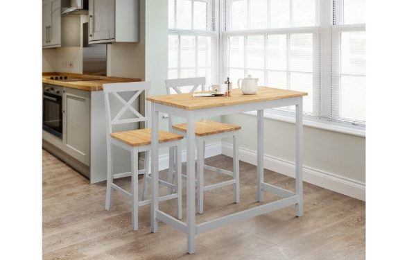 Kitchen with a wooden table and stools in front of a window.