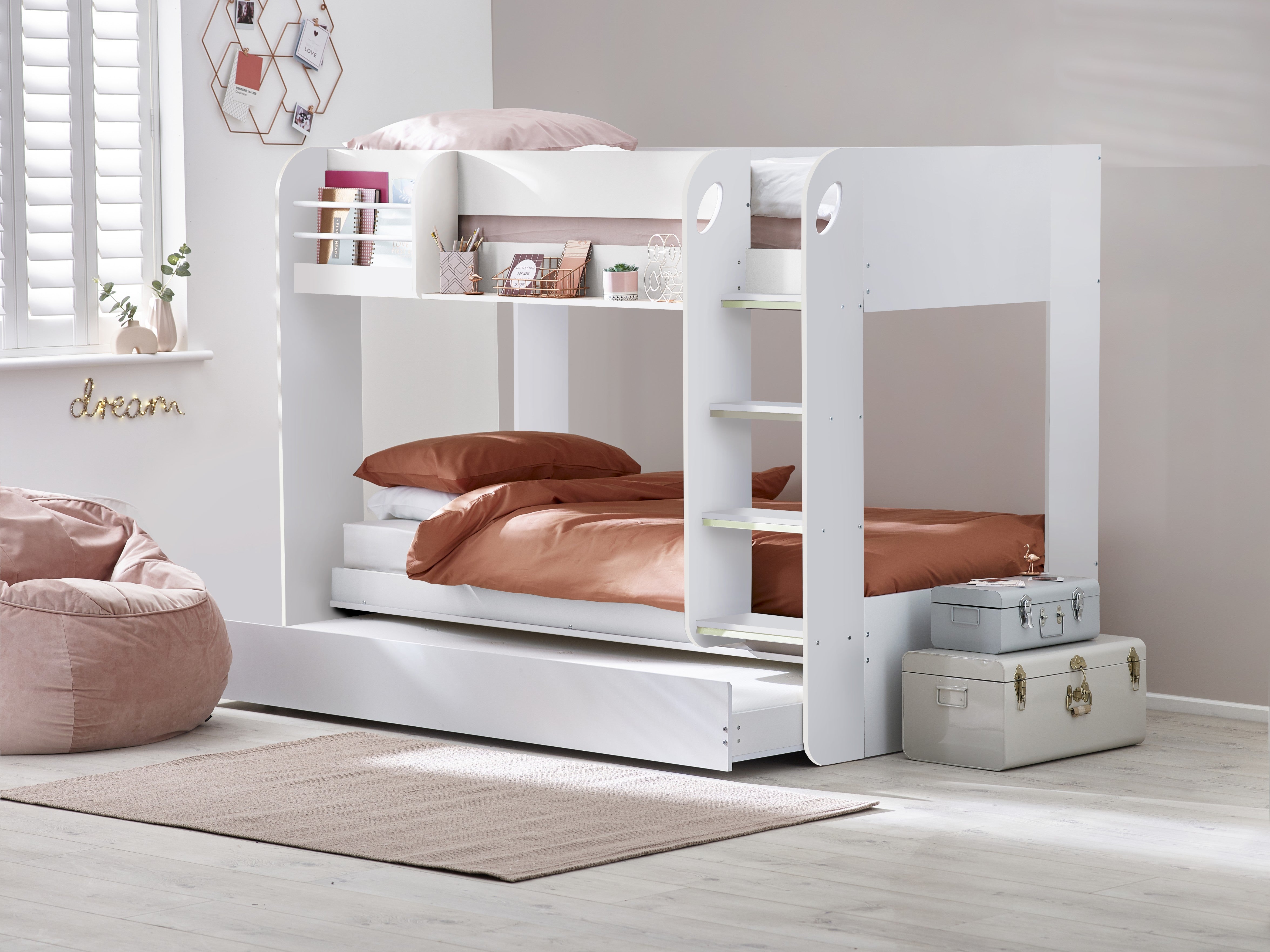 White bunk bed with brown bedding in a room setting