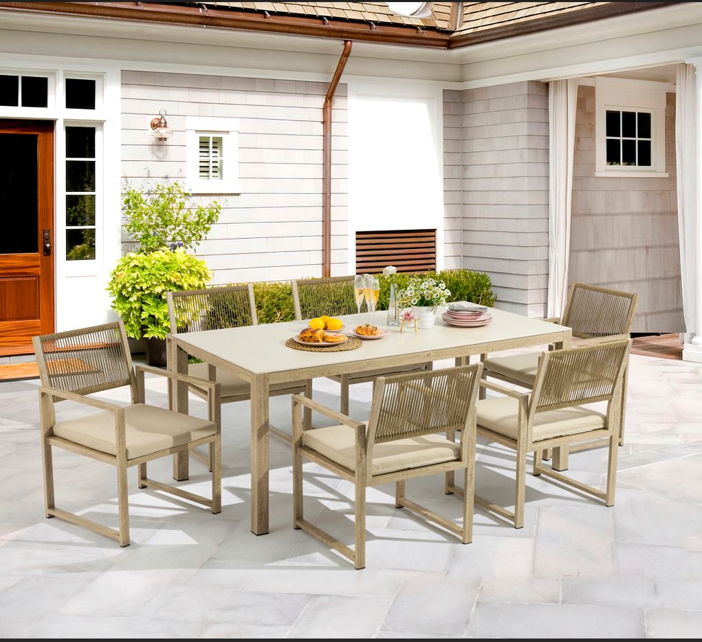 Outdoor patio set with table and chairs on a patio area.