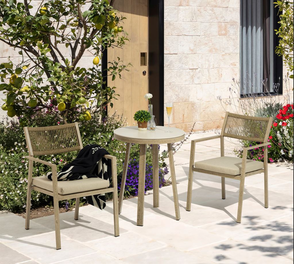 Outdoor patio set with two chairs and a table in a garden setting.