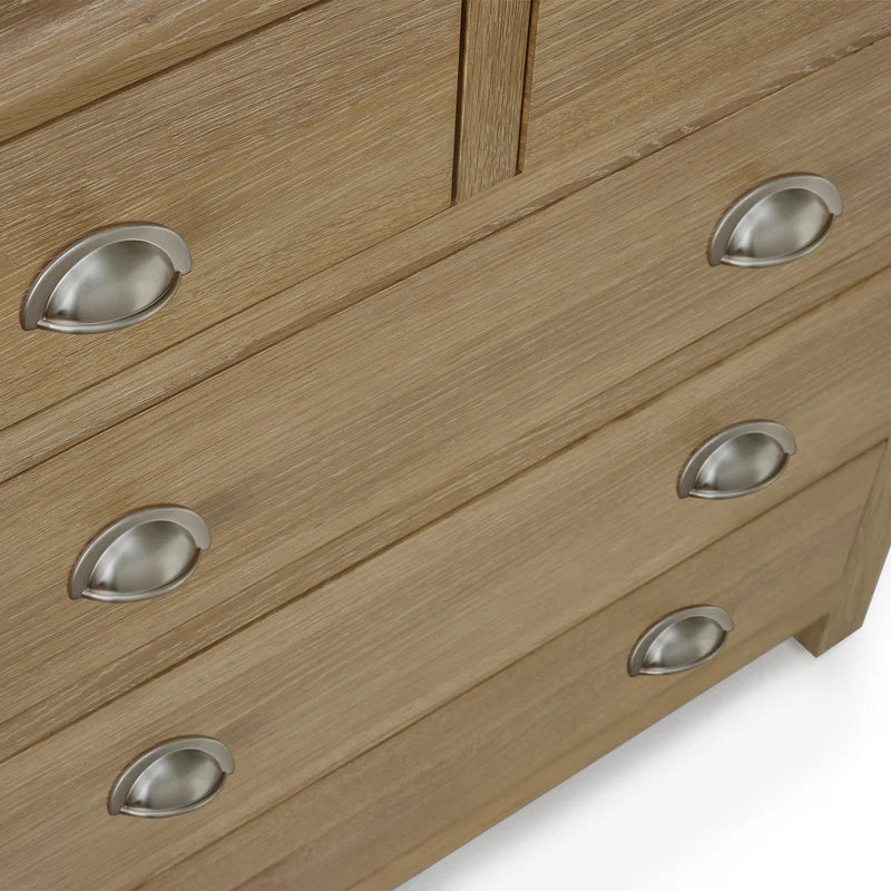 Wooden dresser with metal handles on a white background