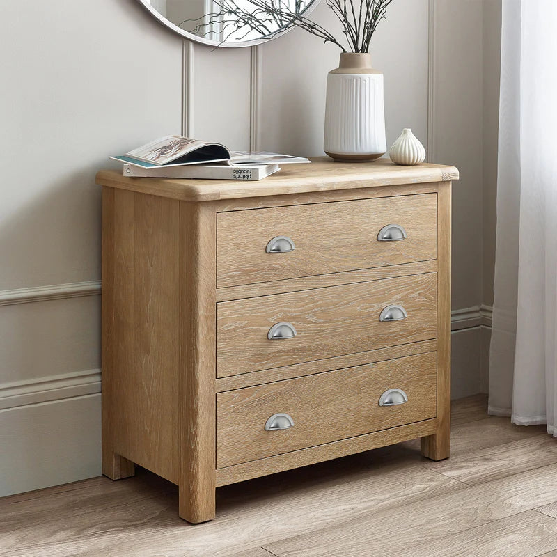 Wooden dresser with silver handles in a room setting