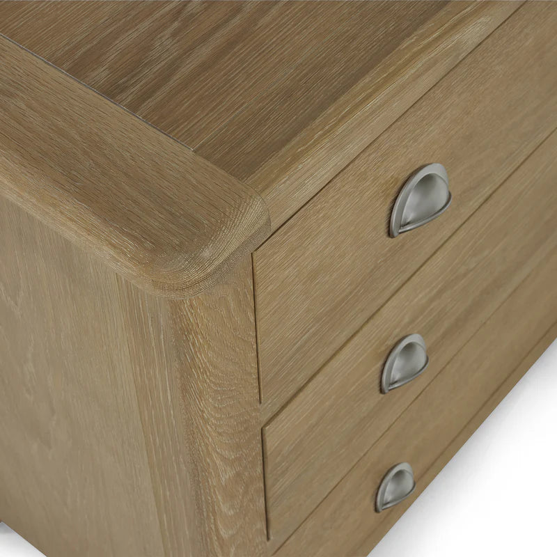 Wooden drawer unit with metal handles on a white background