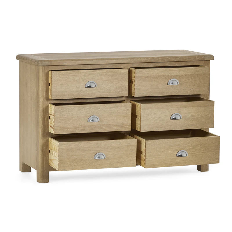 Wooden dresser with six drawers on a white background