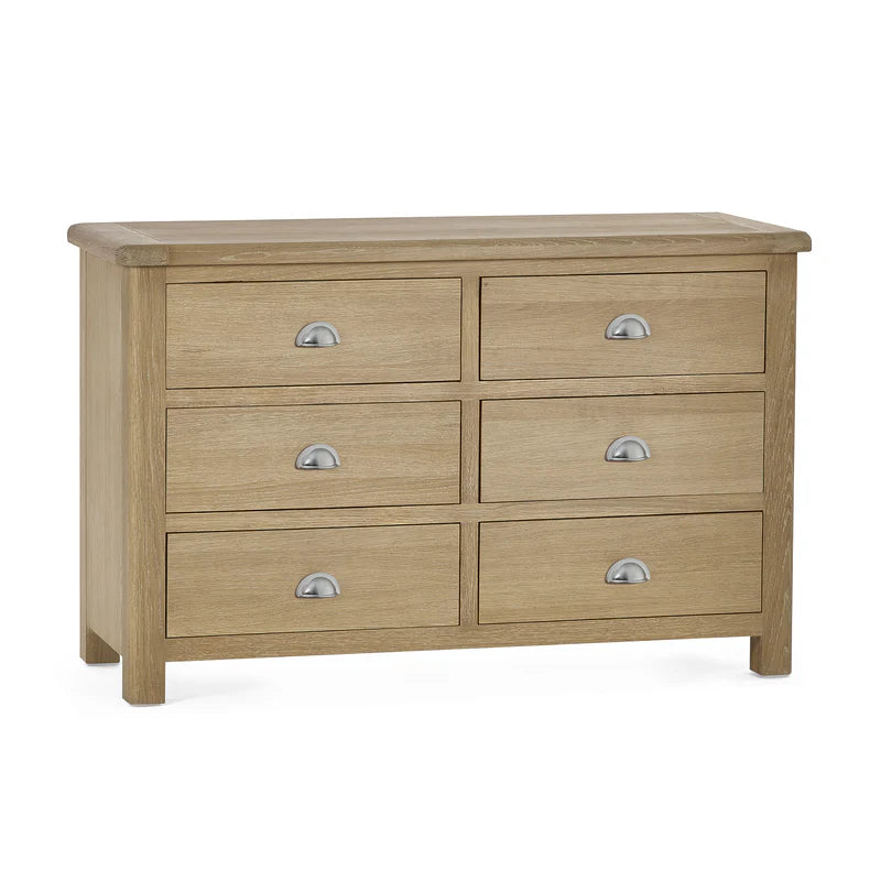Wooden dresser with six drawers on a white background