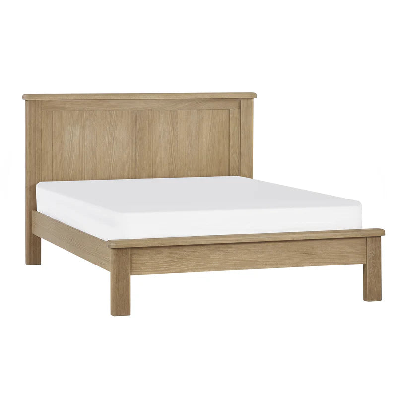 Wooden bed frame with a white mattress on a white background