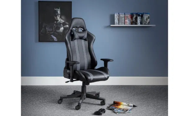 Black gaming chair in a room with a blue wall, shelf, and Batman poster.