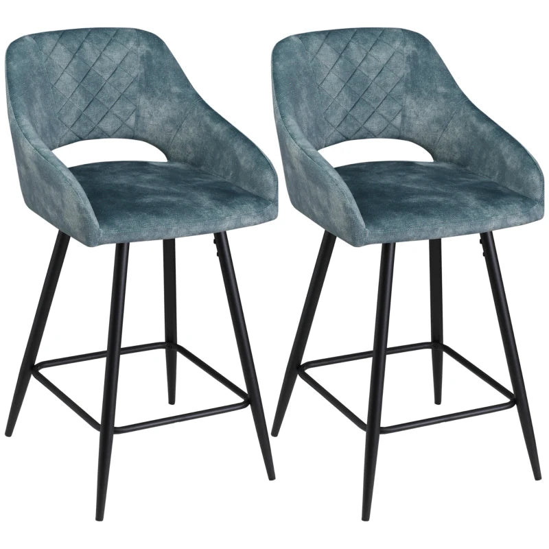 Two blue bar stools with black legs on a white background