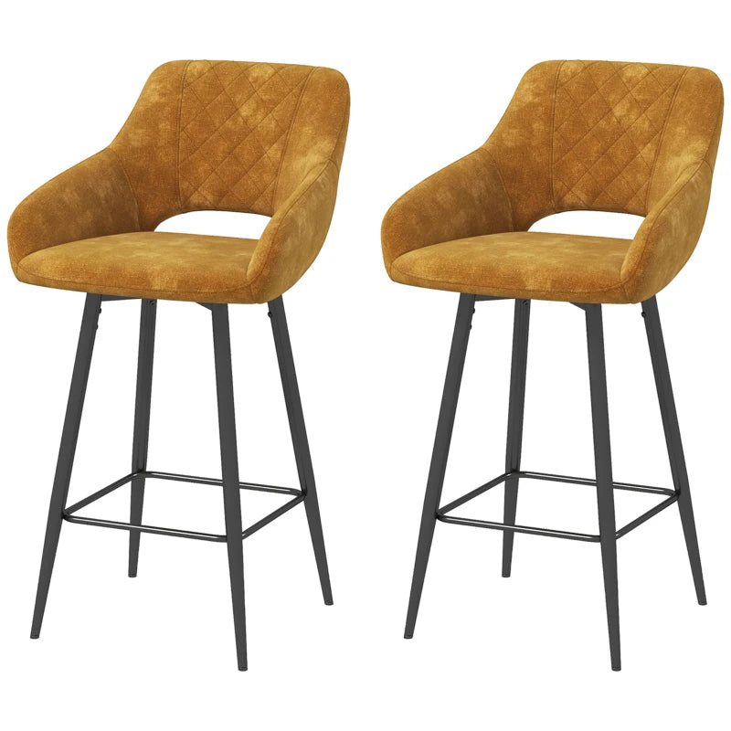 Two mustard yellow bar stools with black legs on a white background