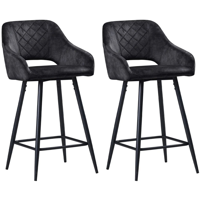 Two black bar stools with quilted design on a white background