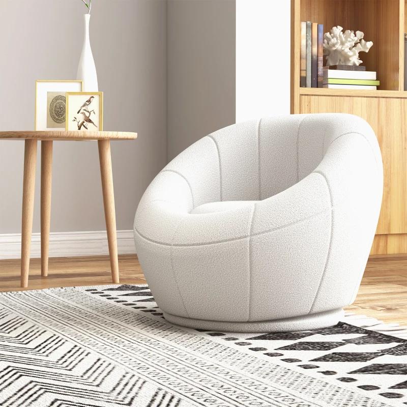White armchair in a room with a wooden side table and bookshelf.